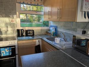 a kitchen with a sink and a counter top at 21 The Glade in Bude