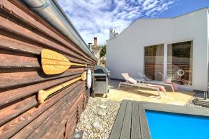 a backyard with a wooden fence and a swimming pool at Charming villa Darte with private pool near Rovinj, extra pool heating available in Kanfanar
