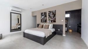 a bedroom with a large bed and a mirror at Casa Familia in Grote Berg