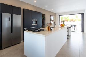 a kitchen with black cabinets and a white counter top at Casa Familia in Grote Berg