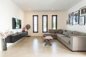 a living room with a couch and a table at Casa Familia in Grote Berg