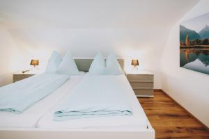 a bedroom with two beds and a painting on the wall at Mooslodge in Kaprun