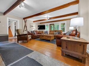 a living room with a couch and a table at Rockin Rhody Retreat in Rhododendron