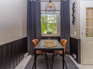 a table and chairs in a room with a window at Holiday Home Levin mini by Interhome in Sirkka