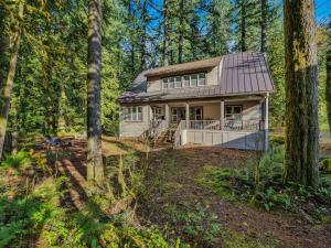 a house in the woods with trees at Rockin Rhody Retreat in Rhododendron