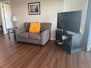 a living room with a couch and a flat screen tv at Lake Ozarks Get Away in Lake Ozark