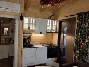 a kitchen with white cabinets and a sink at Etna Baite Milo in Milo