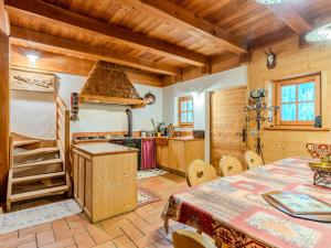 a dining room with a table and a kitchen at Chalet Maset Pozzati by Interhome in Bresimo