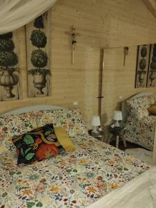 a bedroom with a bed with a comforter on it at Etna Baite Milo in Milo