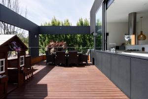 a patio with a table and chairs on a deck at Modern Newnham Retreat in Newnham