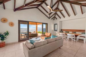 a living room with a couch and a table at Casa Tranquilidad in Willemstad