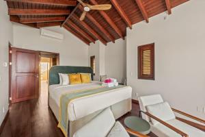 a bedroom with a large bed and a wooden ceiling at Casa Tranquilidad in Willemstad