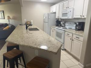 a kitchen with white appliances and a counter top at Lake Ozarks Get Away in Lake Ozark
