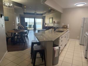 a kitchen with a counter and a dining room at Lake Ozarks Get Away in Lake Ozark +23 photos