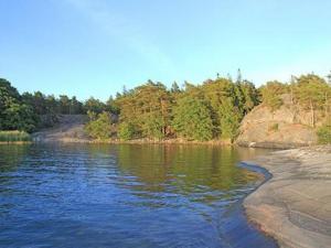 a body of water with trees in the background at Holiday Home Västantill by Interhome in Hitis