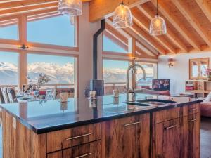 a kitchen with a large island with a view of mountains at Chalet Chalet Flocon de Neige by Interhome in Nendaz