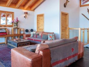 a living room with a couch and a table at Chalet Chalet Flocon de Neige by Interhome in Nendaz +41 photos