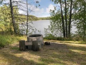 a metal tub sitting next to a body of water at Holiday Home Kivilöytö by Interhome in Mouhu