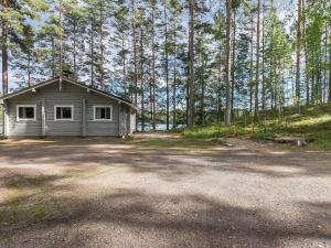 a small house in the middle of a forest at Holiday Home Kivilöytö by Interhome in Mouhu