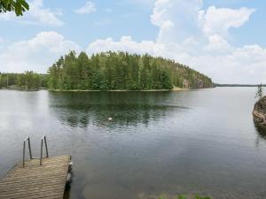 a view of a lake with a dock at Holiday Home Salmela by Interhome in Ollila