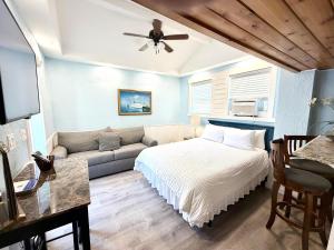 a bedroom with a bed and a couch at Welcome Matt's - Truman @ Duval Unit B in Key West