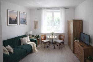 a living room with a green couch and a table at Gdynia99 in Gdynia