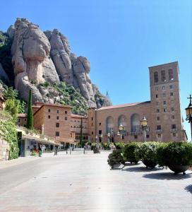 a building with a mountain in the background at Casa Añeja in Collbató