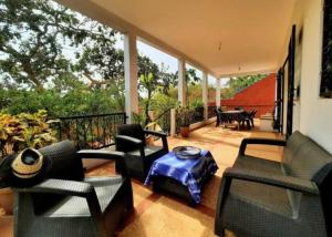 a screened in porch with chairs and a table at Villa AfricaSolly in Poponguine