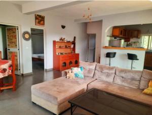a living room with a couch and a table at Villa AfricaSolly in Poponguine