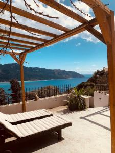 a wooden pergola with a view of the water at Vita vi in Afionas