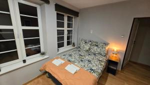 a small living room with a couch and a bed at 4 Lions Guest House in Gdańsk