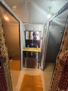 a bathroom with a sink and a mirror in a tent at Mustapha Camp Merzouga in Merzouga