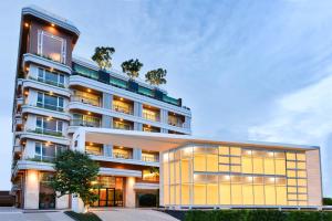 an apartment building with a yellow facade at Hisea Huahin Hotel in Hua Hin