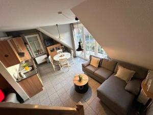 an overhead view of a living room with a couch and a table at Möwennest in Norden
