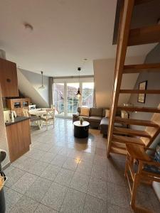 a living room with a couch and a table at Möwennest in Norden