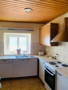 a kitchen with a stove and a sink and a window at ventus in Afionas
