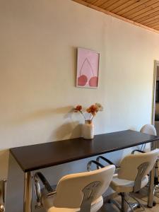 a dining room table with chairs and a vase with flowers at ventus in Afionas