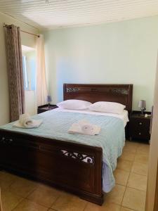a bedroom with a bed with two towels on it at ventus in Afionas +2 photos