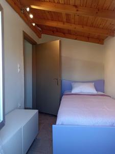 a bedroom with a large bed and a door at ventus in Afionas