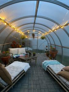 a covered patio with beds and a table and lights at Coastal Vineyard Hideaway in Torres Vedras +24 photos