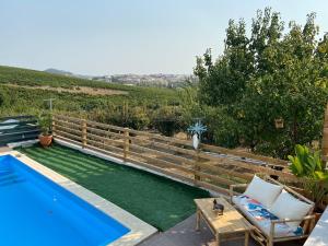 a swimming pool with a table and chairs next to it at Coastal Vineyard Hideaway in Torres Vedras