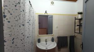 a bathroom with a sink and a mirror at Alentejo Colours Avis in Avis +18 photos