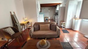 a living room with a couch and a table at Alentejo Colours Avis in Avis