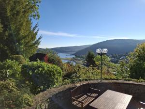 a wooden bench sitting on top of a stone wall at Ferienhaus am Rursee - Haus Eiche in Simmerath +24 photos