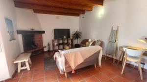 a living room with a couch and a fireplace at Alentejo Colours Avis in Avis