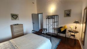 a bedroom with a bed and a table and a lamp at Alentejo Colours Avis in Avis