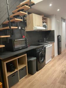 a kitchen with a washer and dryer in a room at L ADRET - Duplex 6 pers 2 chambres - Belle Plagne PARADISKI in La Plagne Tarentaise +13 photos
