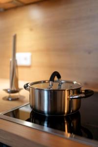 a large metal pot sitting on top of a stove at Das Chalet in Himmelkron
