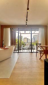 a large bathroom with a tub and a view of the city at Azurine Pousada in Passo de Torres