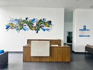 an office with a reception desk in a room at Departamento frente al mar - Resort Playa Azul in Tonsupa +13 photos